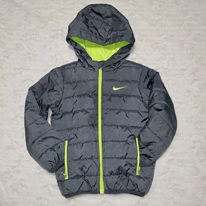 Nike kids navy puffer jacket with lime green accents.